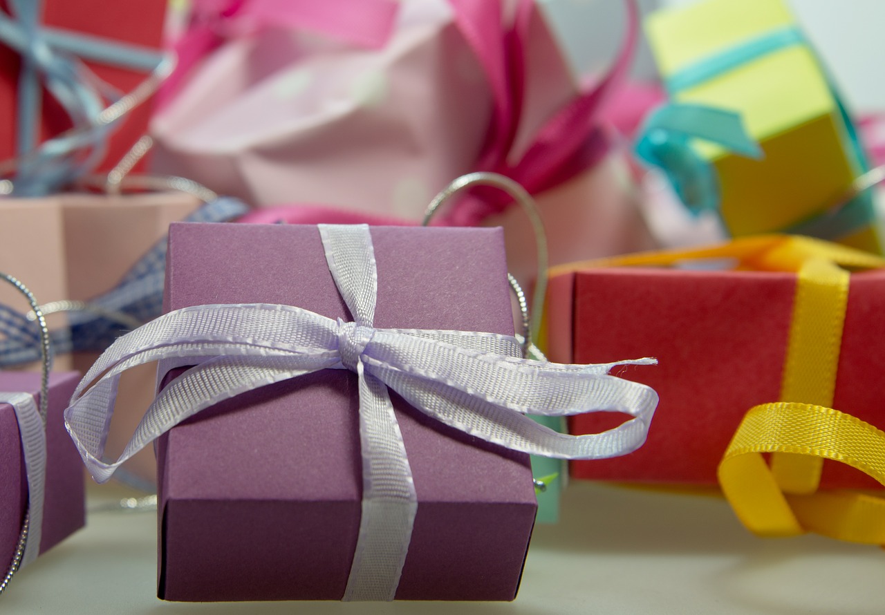 A bunch of neatly wrapped gifts with bows.