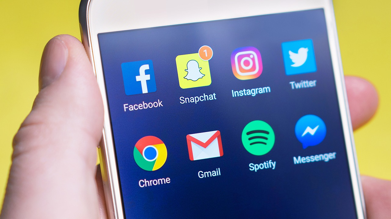 A cell phone with various social media icons on it.