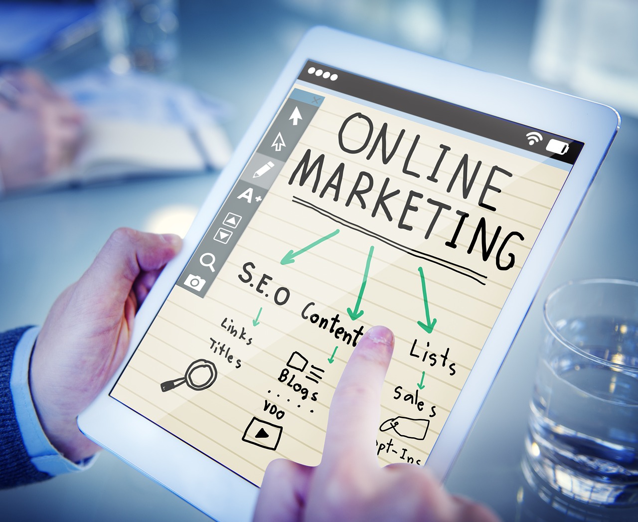 A picture of a tablet with online marketing tools written on it.