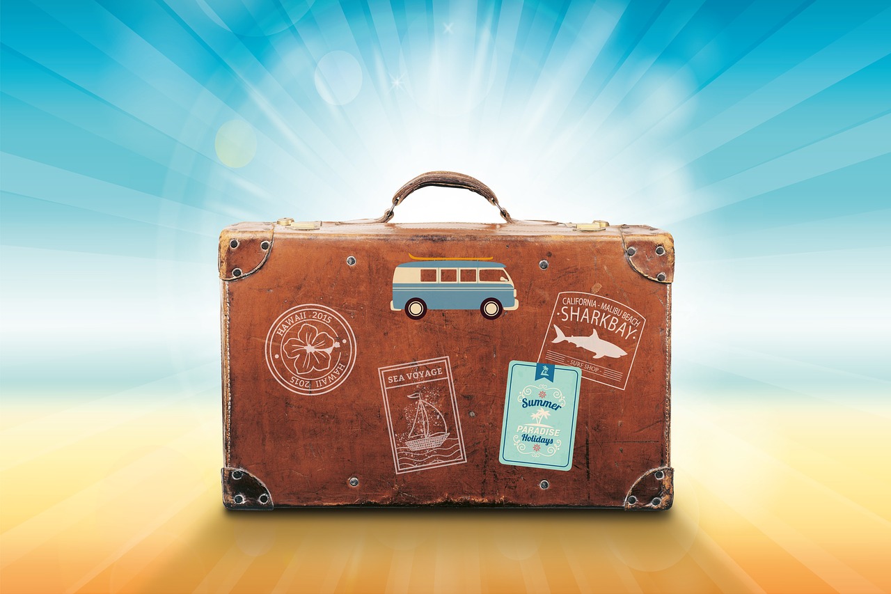 A suitcase with stickers on it from other places, indicating travel.