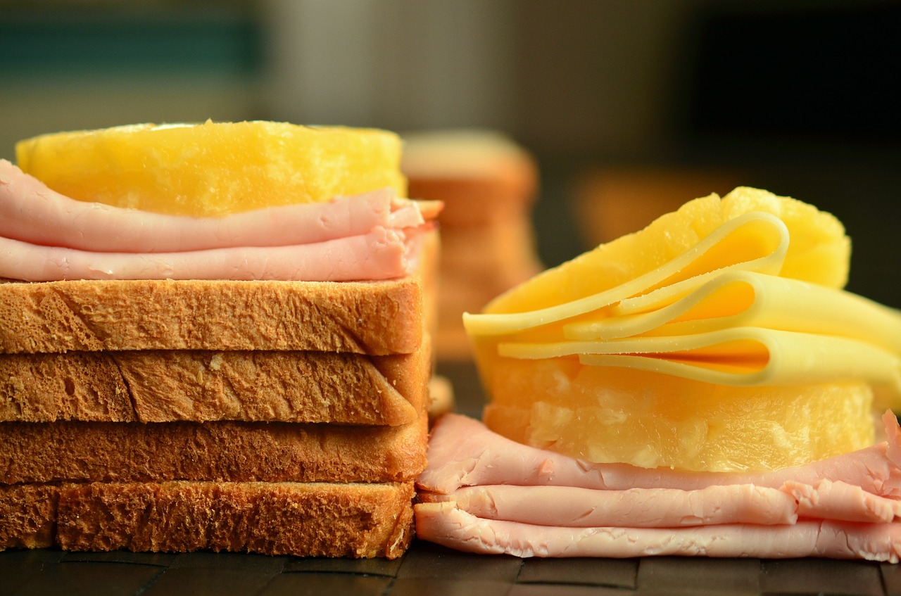 Sliced cheese and meat on bread.