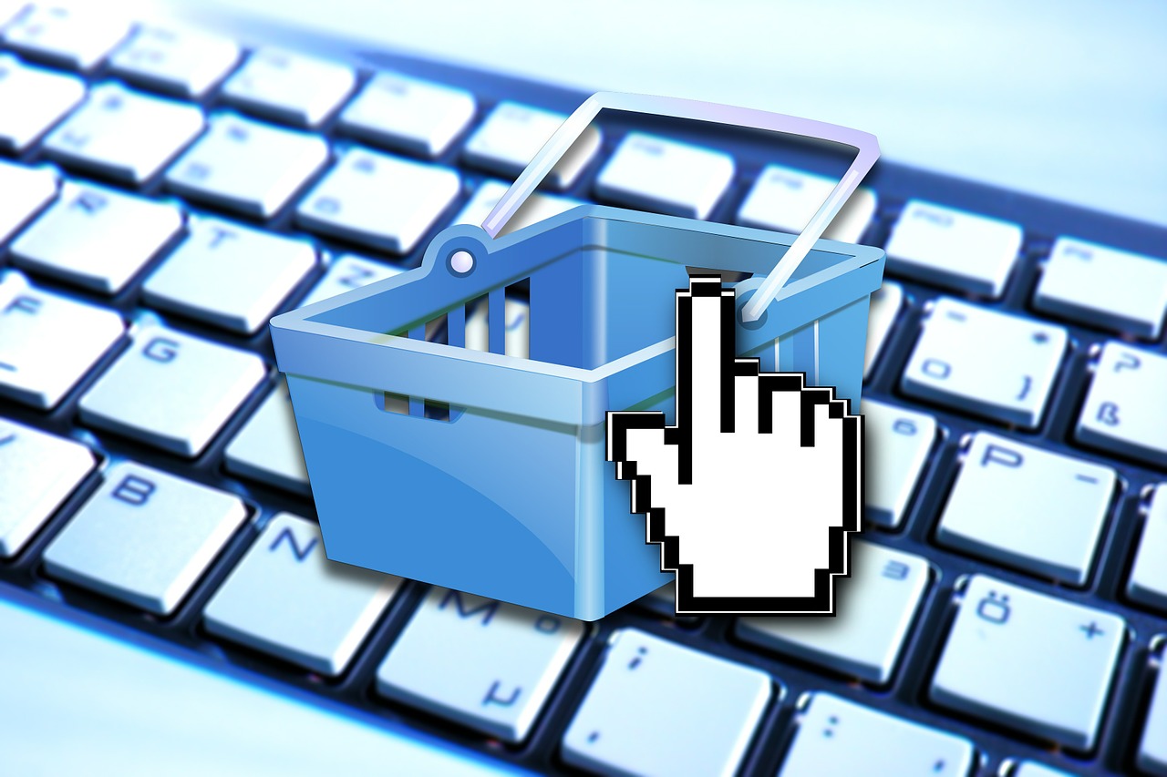 A shopping basket graphic placed in front of a computer keyboard.
