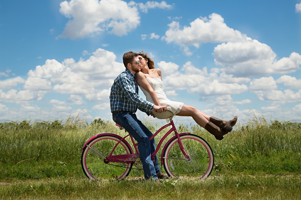 Couple riding a bike.