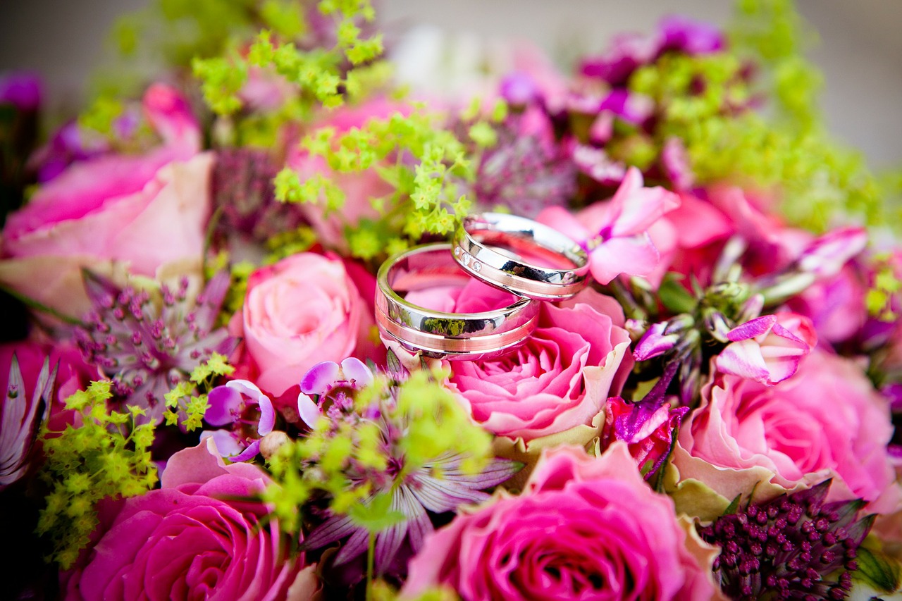 Wedding flowers with wedding rings in the center.