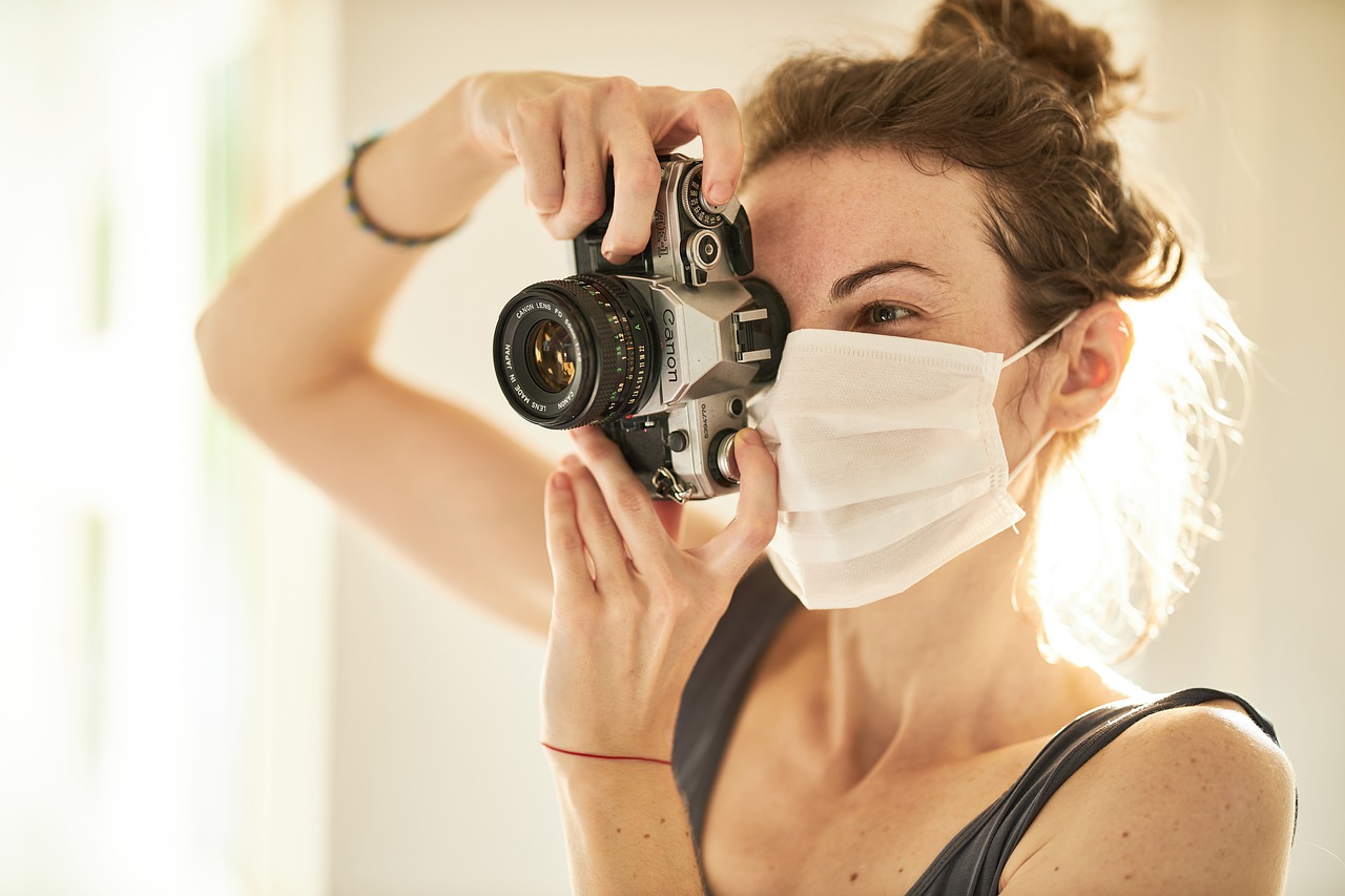 Person wearing a COVID mask and taking a picture.
