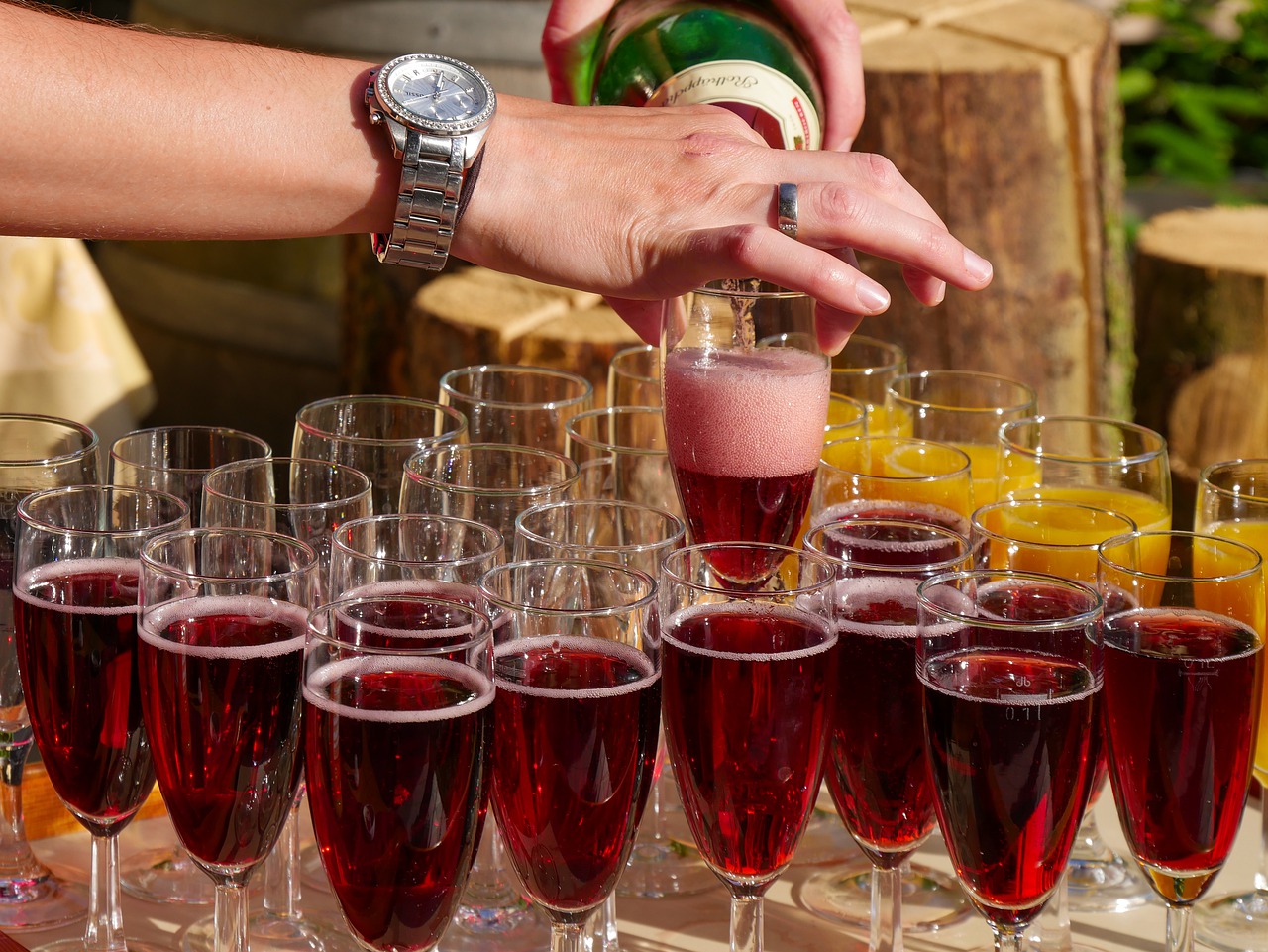Person pouring alcoholic drinks.