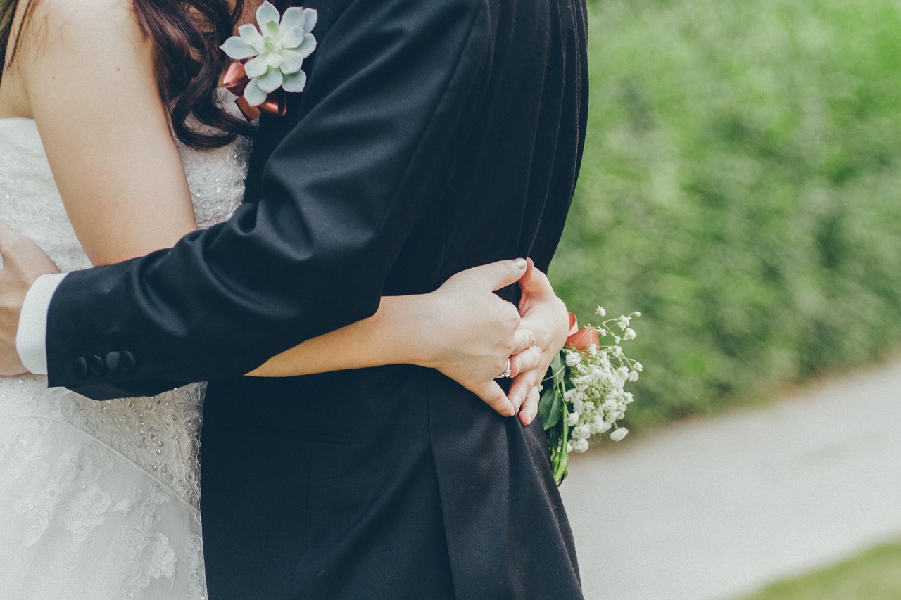 Bride and groom hugging.